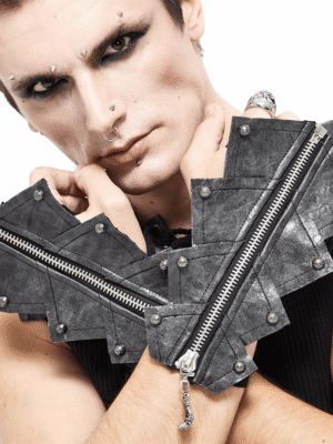 Gothic male model wearing black fingerless gloves with skull zipper, showcasing dark makeup and goth aesthetic with metal rivet details
