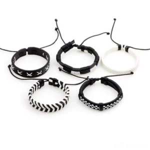 Five-piece adjustable woven gothic bracelet collection in black, white, and cream tones - top-down flat lay