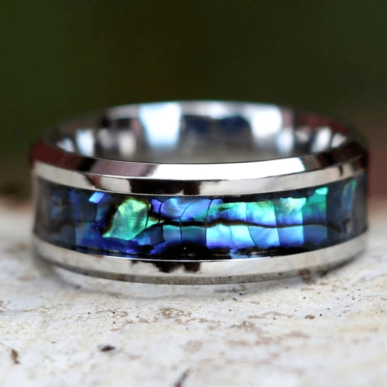 Stainless steel abalone ring flat overhead view showing symmetrical inlay structure