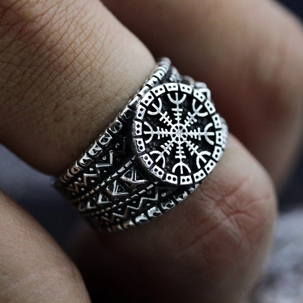 Gothic protection ring worn on human finger - close-up side view showing vintage silver stainless steel