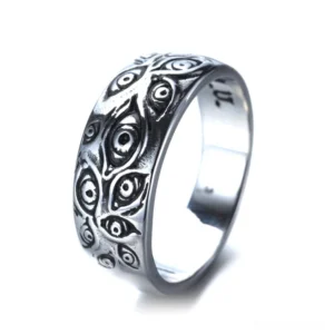 Carved all-seeing eye gothic ring - left side view showing intricate embossed eye motifs in antiqued silver zinc alloy