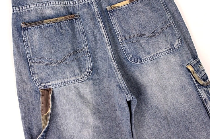 Loose fit men's denim cargo capri shorts detail - cargo pocket construction and faded indigo wash