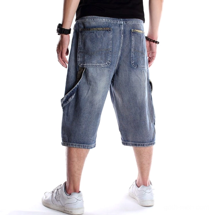 Men's baggy denim capri shorts rear three-quarter view - utility side strap and back patch pockets