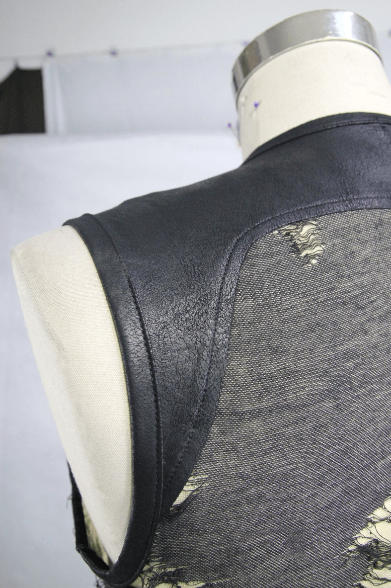 Alternative fashion tank top texture detail showing frayed ripped edges and premium polyester knit fabric