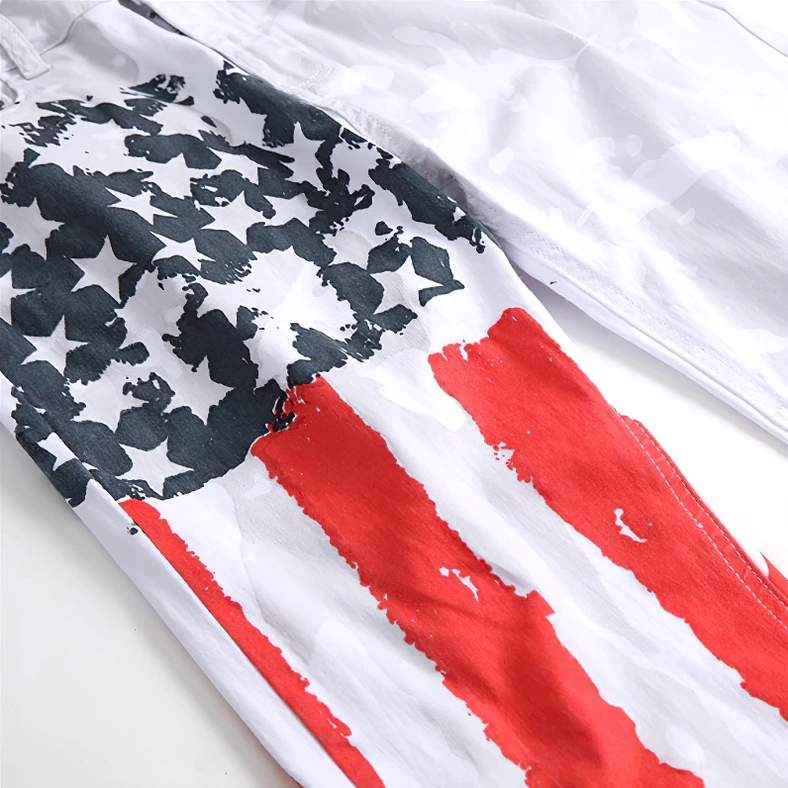 Close-up macro detail of red, white, and blue American flag print stripes and star design on jeans leg