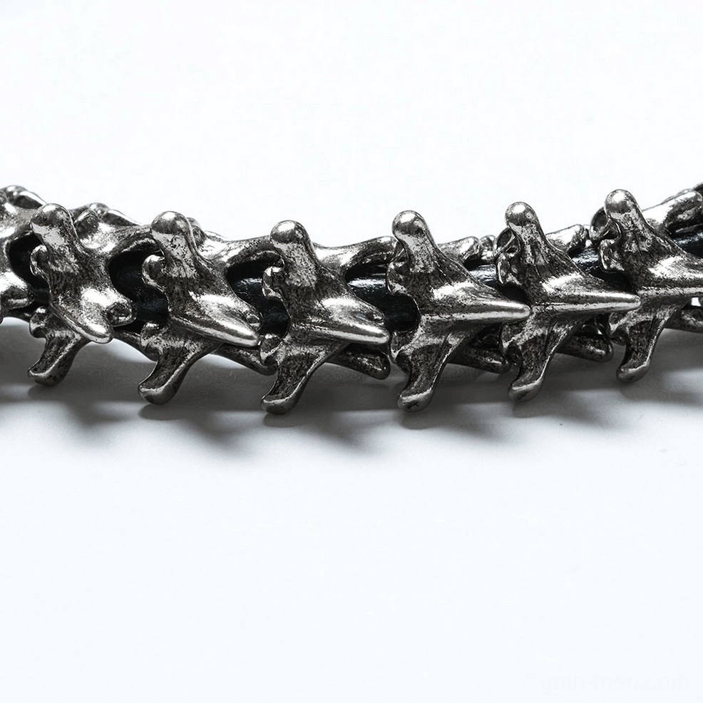 Detailed side flat lay of choker chain links showing realistic vertebrae replicas with interlocking design and aged silver patina