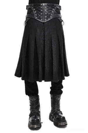Asymmetric black gothic kilt skirt with buckled leather straps worn by model on white background - front full lower view