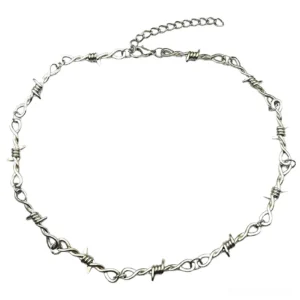 Barbed wire metal thorn chain choker necklace flat lay top-down view on white background, featuring adjustable extension chain and silver tone finish