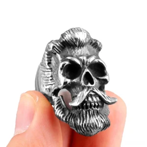 Bearded skull gothic ring held on human finger side profile view showing carved beard details