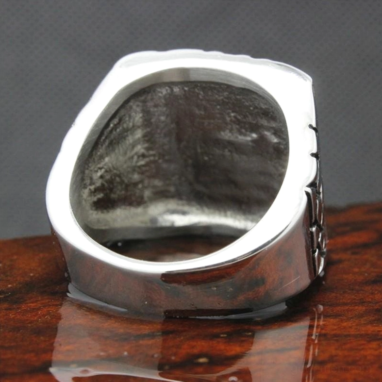 Inner top view of stainless steel biker ring showing smooth inner band and solid metal construction on wooden surface