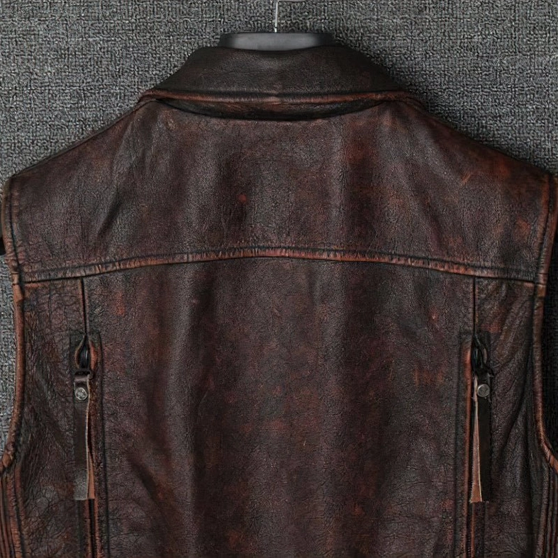 Vintage brown leather gothic biker vest pocket detail and stitching construction close-up
