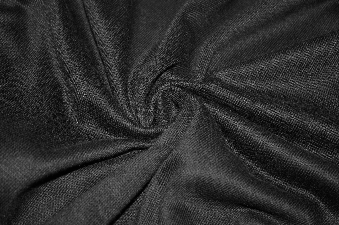 Black asymmetrical gothic sweatshirt side view showing tassel trim and asymmetric cut construction