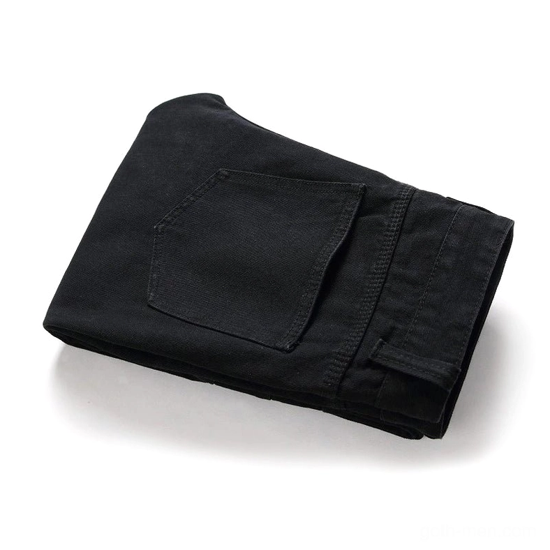 Folded black gothic pleated biker denim pants top-down view showing slim fit cut and single rear pocket