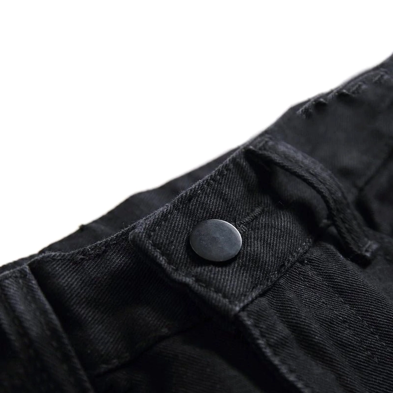 Black gothic biker jeans waistband close-up showing metal snap button, belt loops, and zipper fly hardware