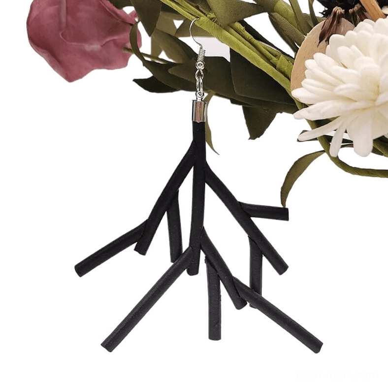 Single black branch dangle earring close-up front view with floral background, showing detailed silicone texture and silver ear hook