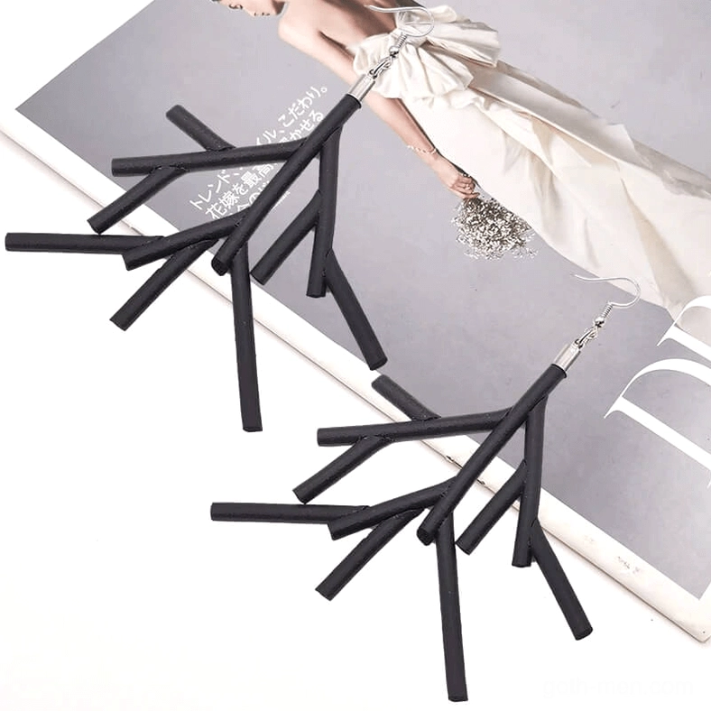 Black branch dangle earrings pair styled on wedding magazine page backdrop, fashion editorial aesthetic gothic jewelry styling