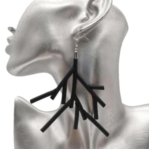 Black branch dangle earrings on silver ear mannequin, close-up left side view showing matte black silicone tree branch design with silver-plated aluminum hook