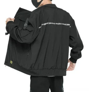 Black cargo bomber jacket with back letter print graphics and side pockets, rear view on model