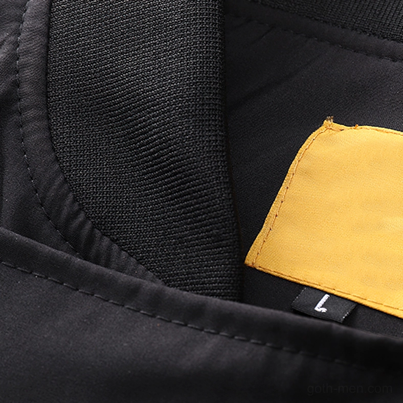 Black cargo bomber jacket interior lining detail showing polyester fabric and yellow brand patch