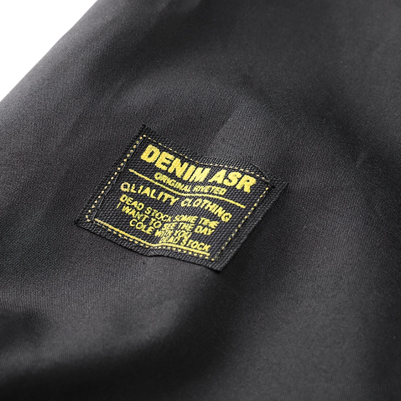 Black cargo bomber jacket pocket strap design with metal buckles and reinforced stitching