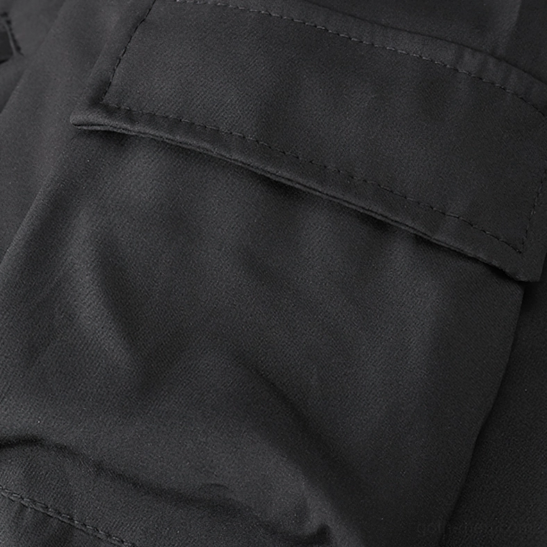 Black cargo bomber jacket sleeve cuff with ribbed trim and metal snap fasteners