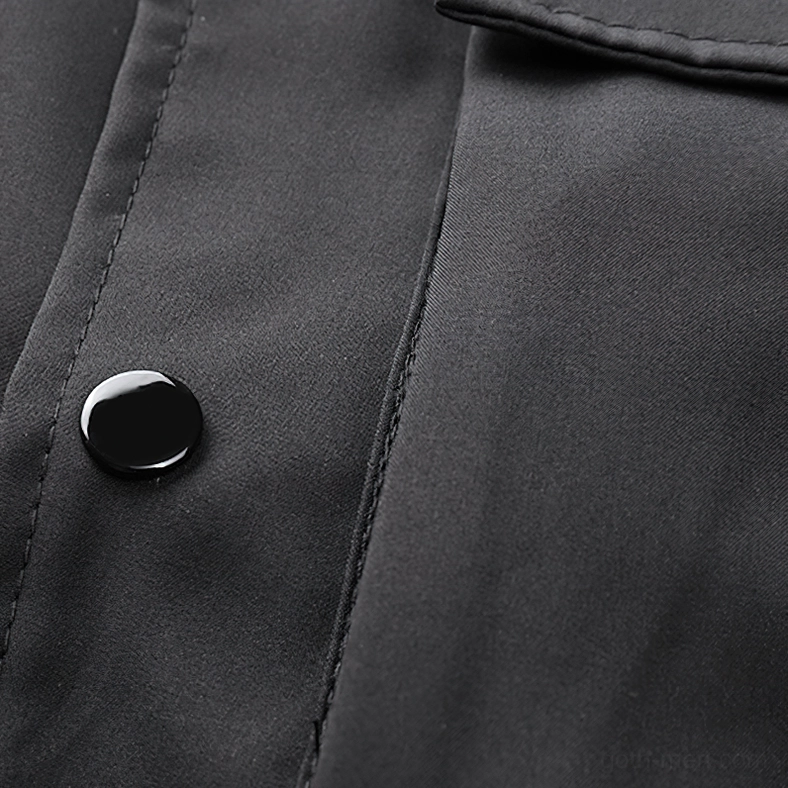 Close-up of black cargo bomber jacket round snap buttons with neat stitching and matte fabric