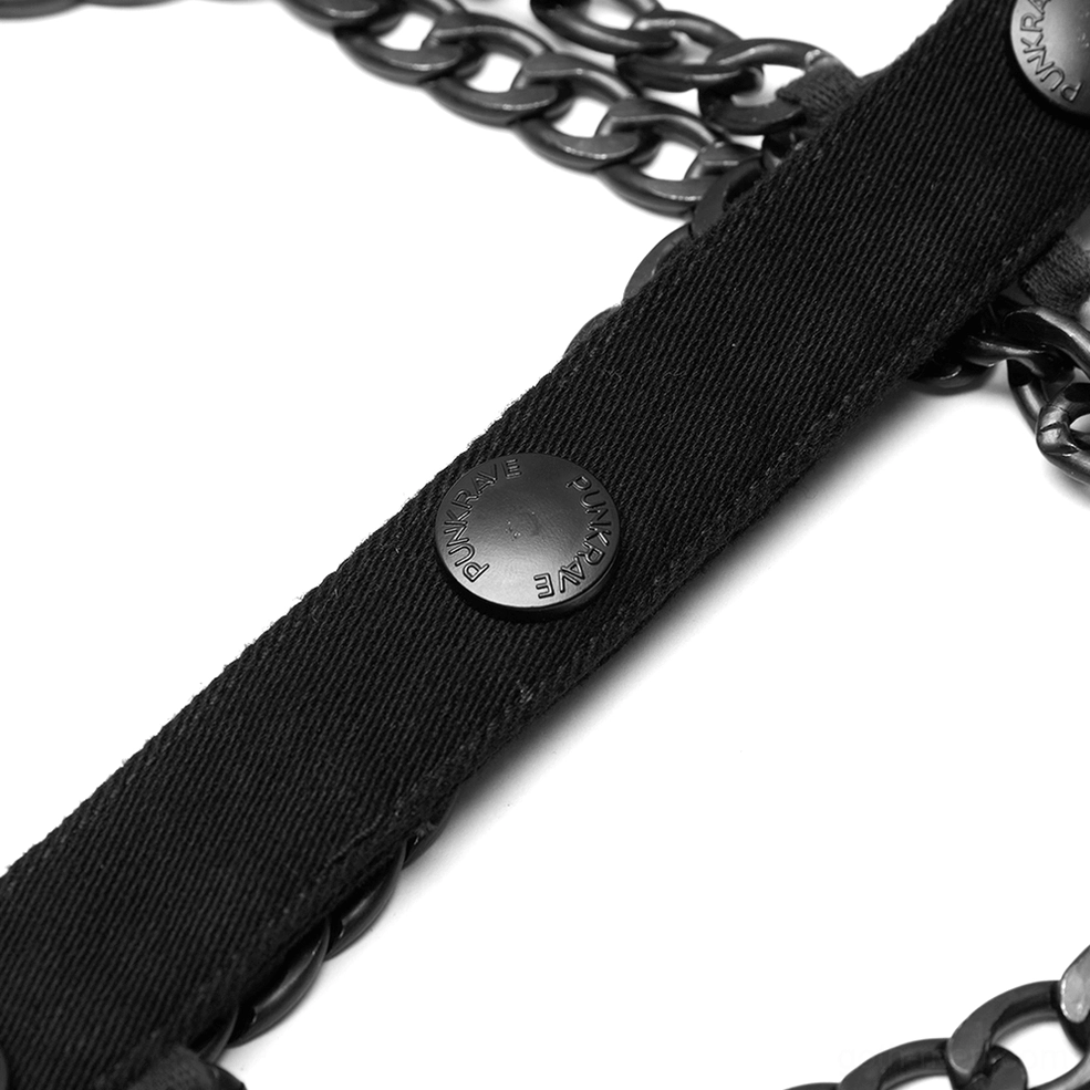Black chain gothic harness vest hardware detail closeup, woven fabric snaps metal attachments, industrial craftsmanship