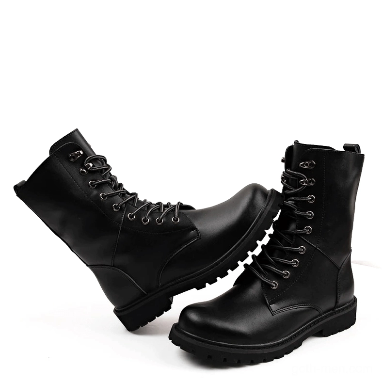 Pair of black lace-up combat boots top-down tilted view, displaying cross-tied lacing system and durable rubber outsole construction