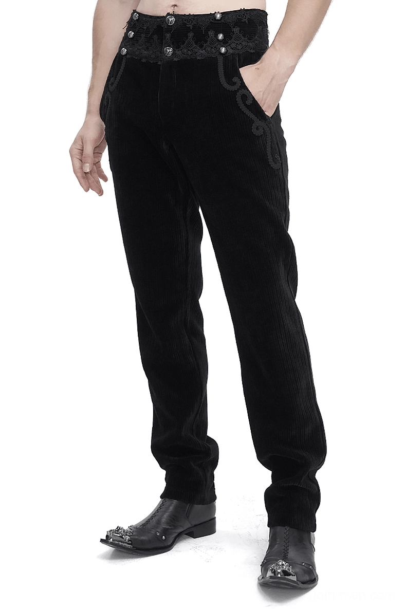 Black corduroy gothic pants with ornate lace waistband front three-quarter view on male model, studio photography