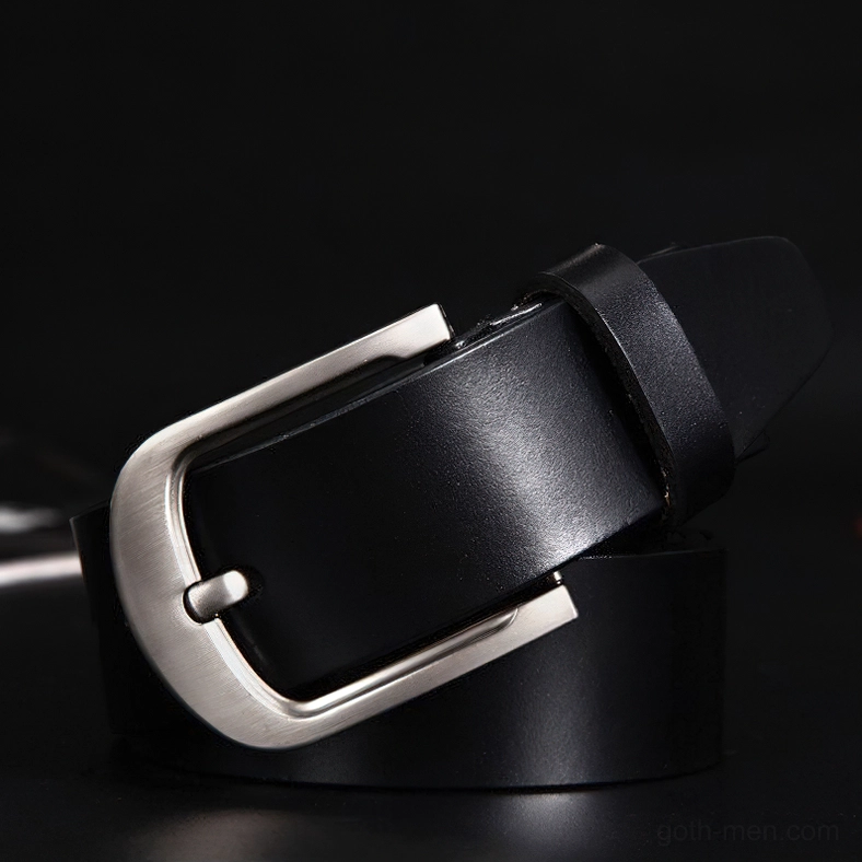 Black cowhide leather belt with smooth texture and matte silver pin buckle, side 3/4 view on dark background