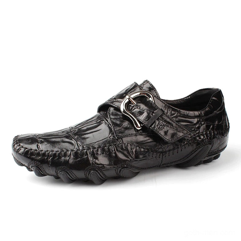 Black crocodile leather gothic loafers with metal buckle strap, three-quarter side view showcasing textured pattern