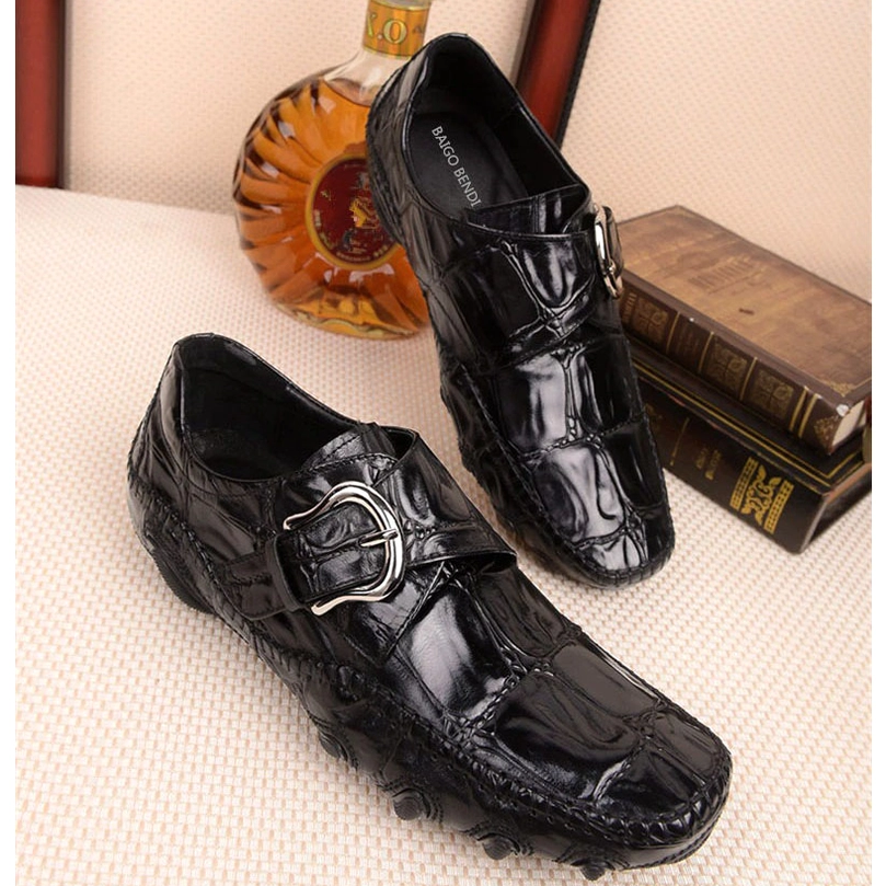 Black crocodile leather men's loafers studio detail shot emphasizing animal print embossing pattern