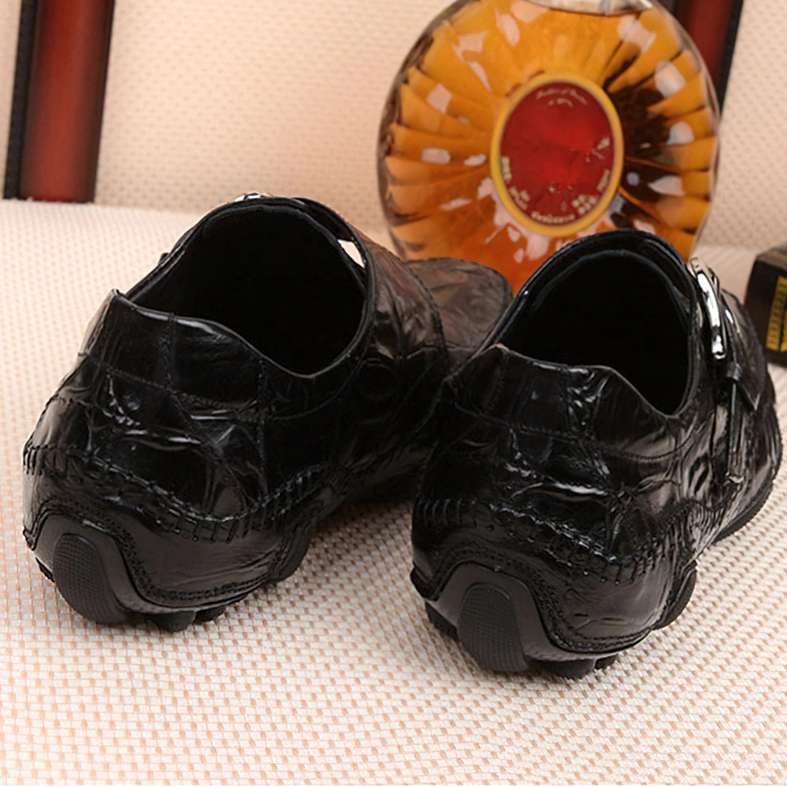 Black crocodile loafers rear pair view with decorative table styling in background