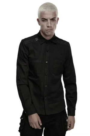 Platinum blonde male model wearing black cyberpunk military shirt with studded shoulders, front view against white studio background