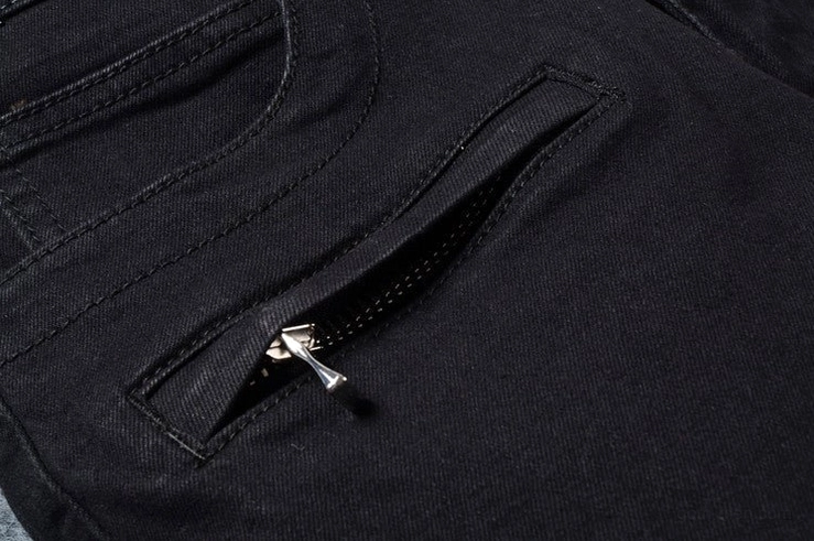Black denim jeans zippered pocket detail - metal zipper pull and pocket construction