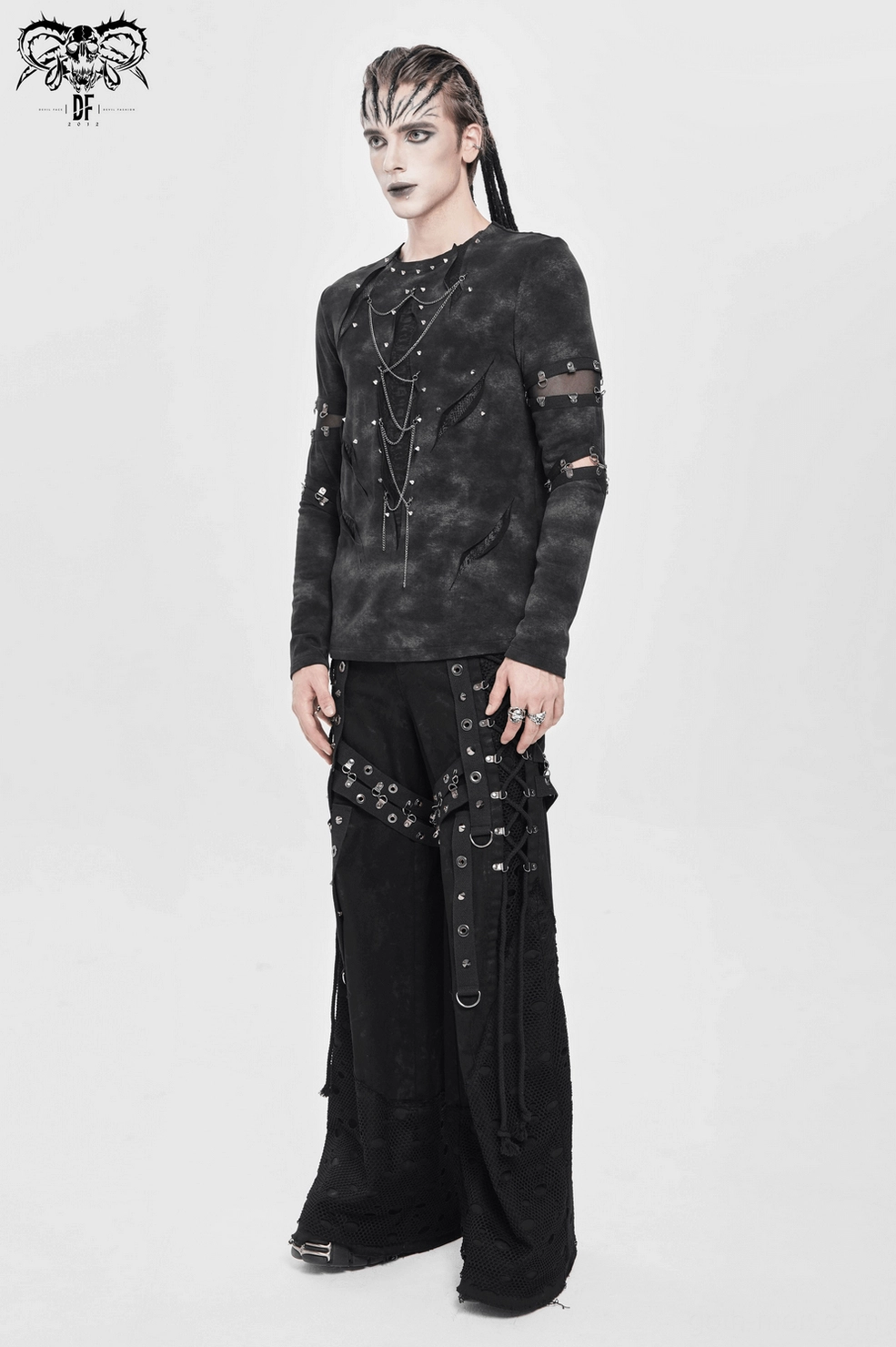 Flat lay detail of black distressed gothic top with tie-dye effect and hardware accents