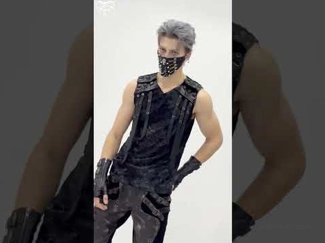 Distressed black gothic tank top styled with punk accessories and goth aesthetic on male model