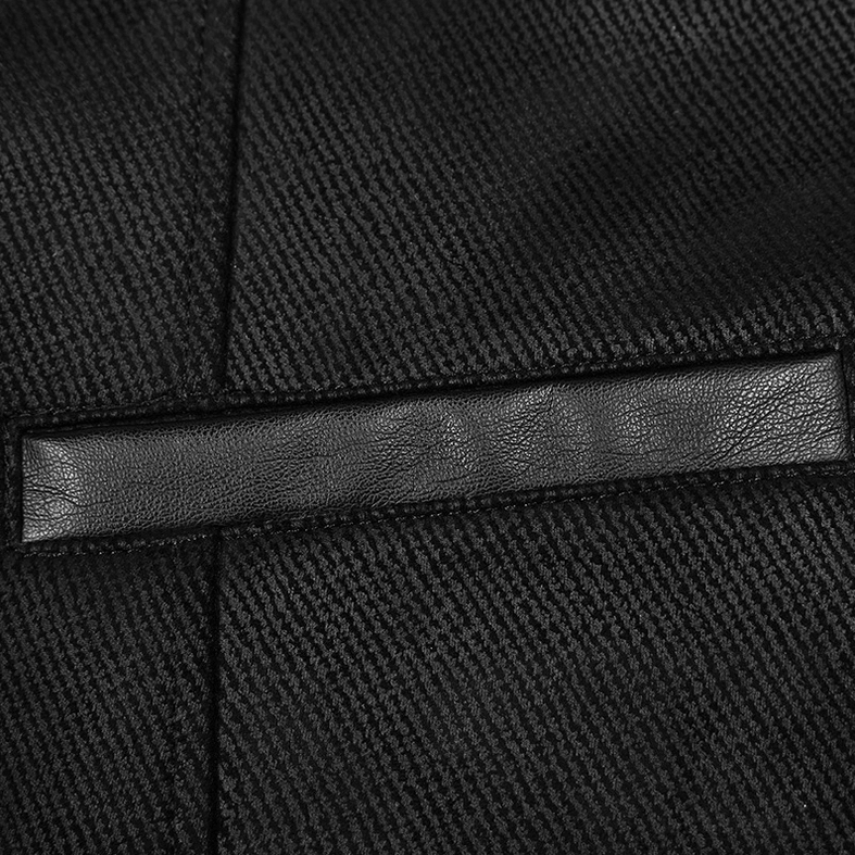 Detail shot of black faux leather accent strip on twill fabric of gothic Victorian waistcoat