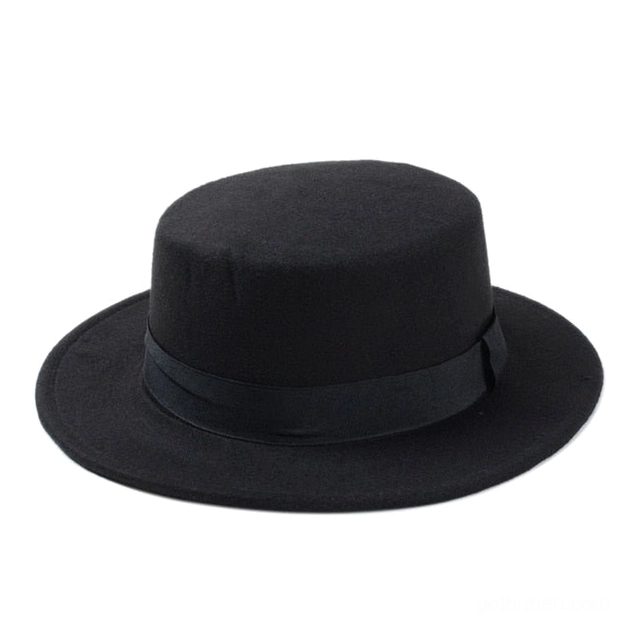 Black flat top fedora in wool felt with structured crown viewed from front overhead angle, gothic alternative hat style