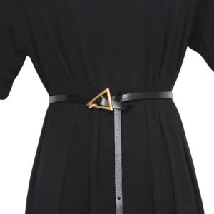 Black geometric triangle buckle gothic waist belt worn on mannequin with black dress, front close-up showing metal buckle detail