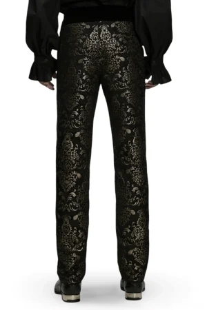 Rear view of black and gold gothic jacquard pants, displaying full all-over damask print pattern and straight leg silhouette from behind