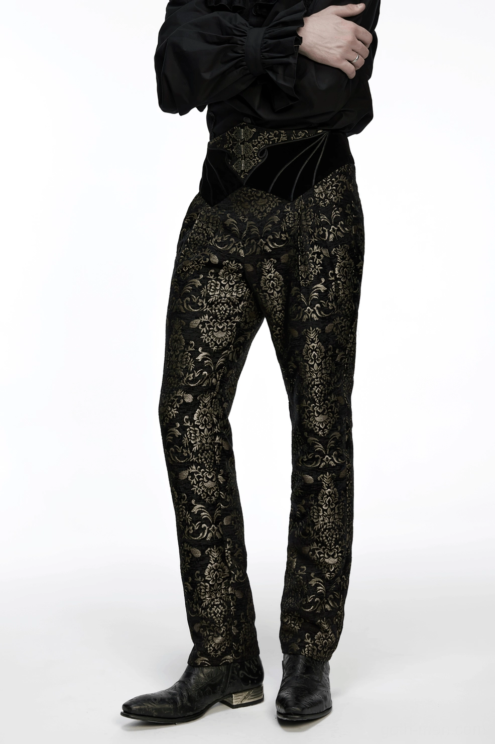 Black and gold jacquard velvet gothic pants displaying waistband embroidery detail and decorative metal button accents in studio lighting