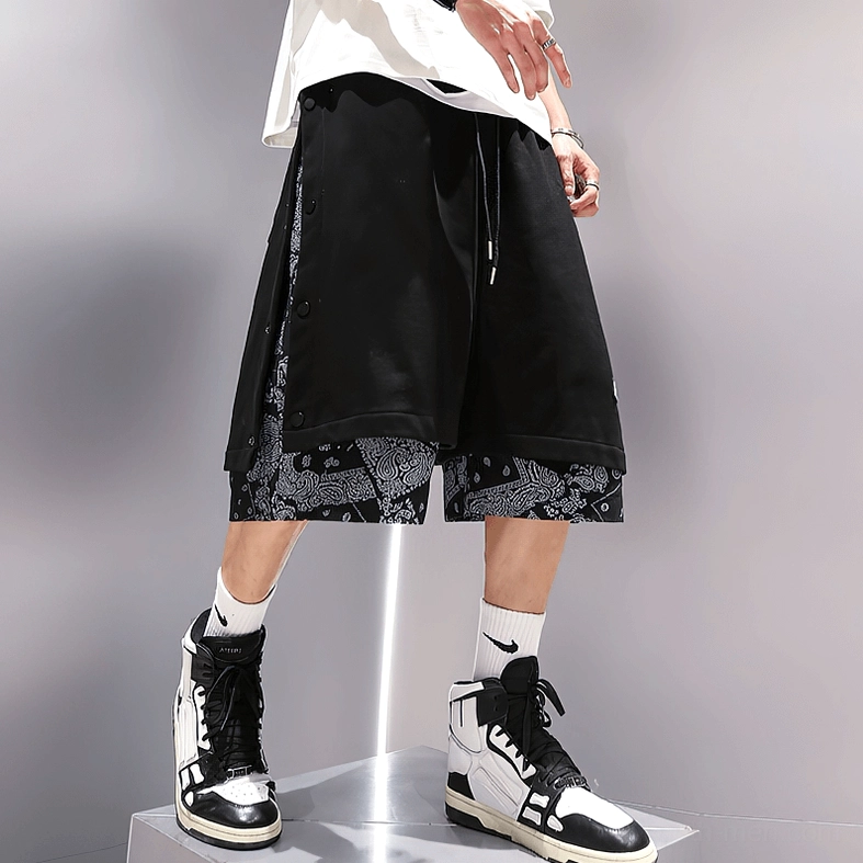 Male model in black gothic shorts with industrial aesthetic, paired with chunky boots and dark clothing