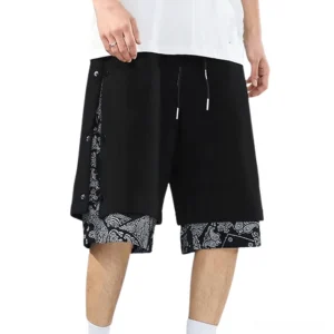 Black goth drawstring shorts with paisley lining detail, front model view showing mid-rise fit and relaxed silhouette