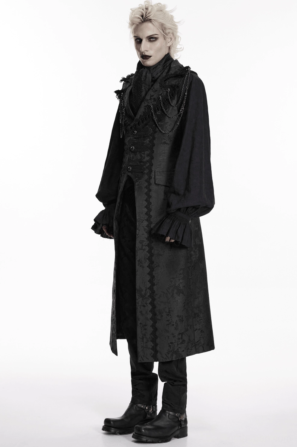 Male model wearing black gothic formal ensemble with jacquard ascot tie and matching outfit, right three-quarter view studio photography