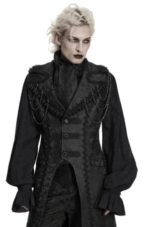 Male model in gothic formal attire featuring black jacquard ascot tie with chain decorations and ruffled cuffs, front full view