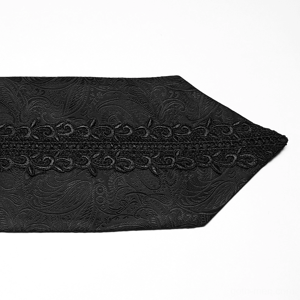 Close-up detail of black gothic ascot tie tip showing paisley jacquard pattern and chain-style embroidery