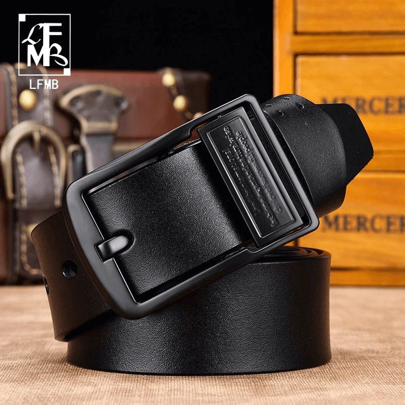 Black gothic leather belt rolled and stacked with rectangular matte metal buckle detail