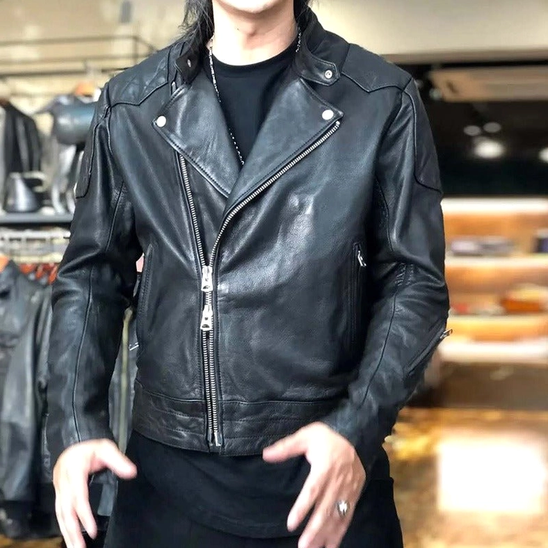 Man wearing black leather gothic biker jacket with black t-shirt in retail clothing store setting