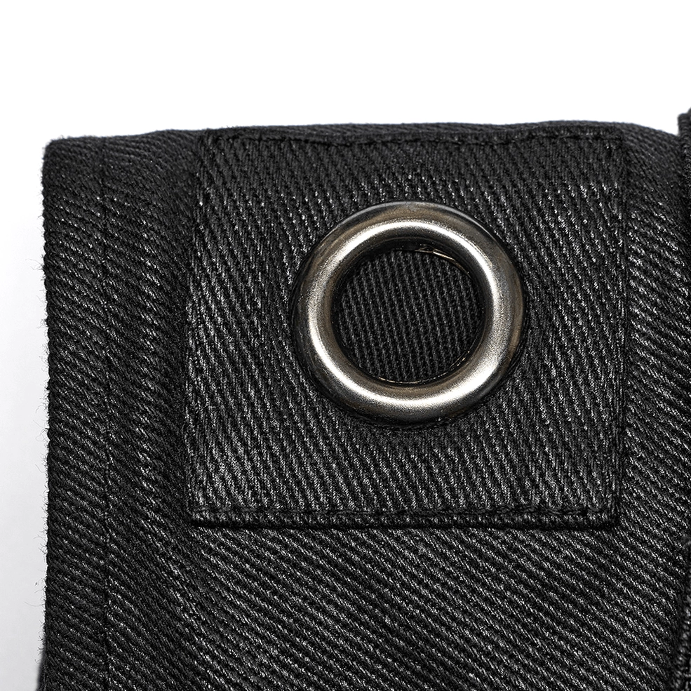 Close-up detail of black gothic buckle vest hardware showing metal round eyelets, thick twill fabric, and reinforced stitching